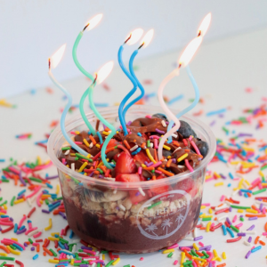 Nu-Stella Acai bowl with 7 birthday candles.
